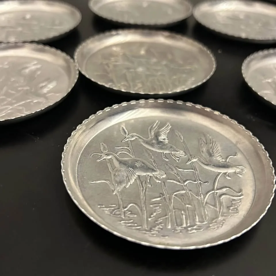 Set of 7 Vintage Embossed Metal Coasters image indicator(6)