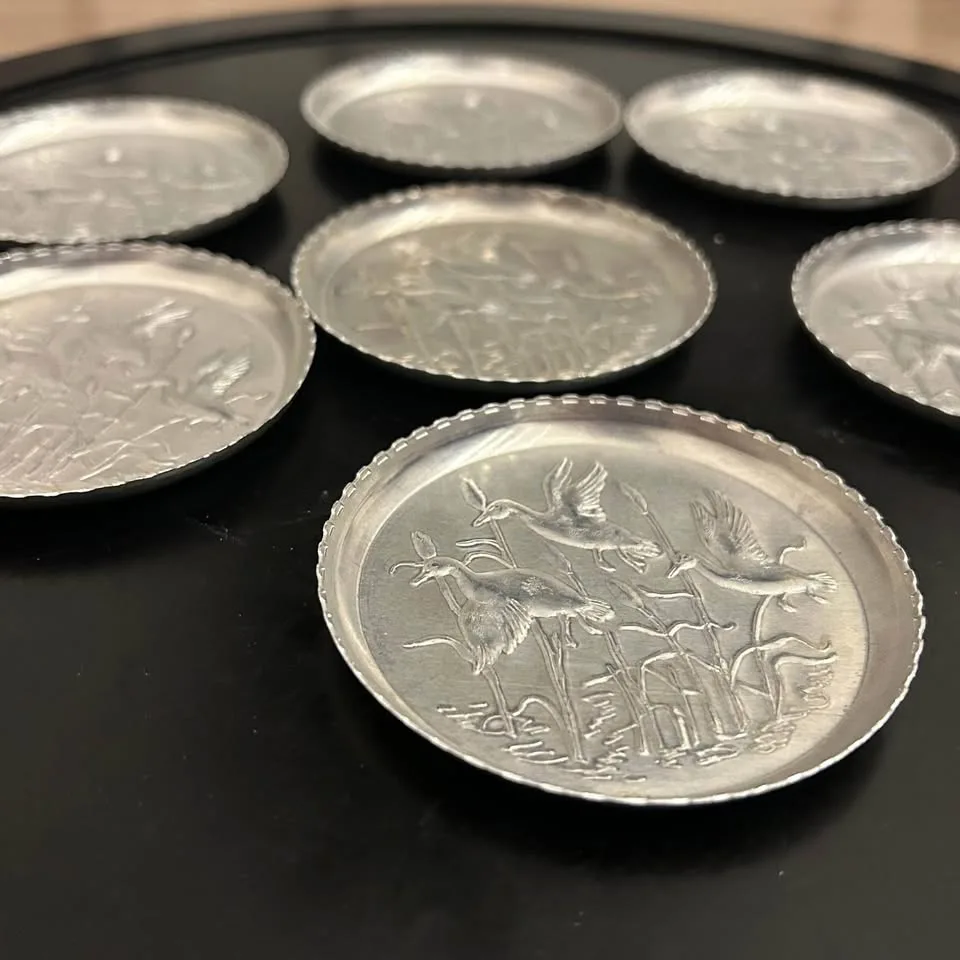 Set of 7 Vintage Embossed Metal Coasters image indicator(7)