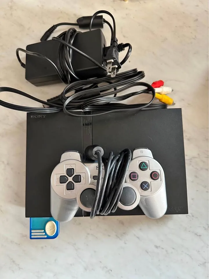 Broken PlayStation 2 with controller