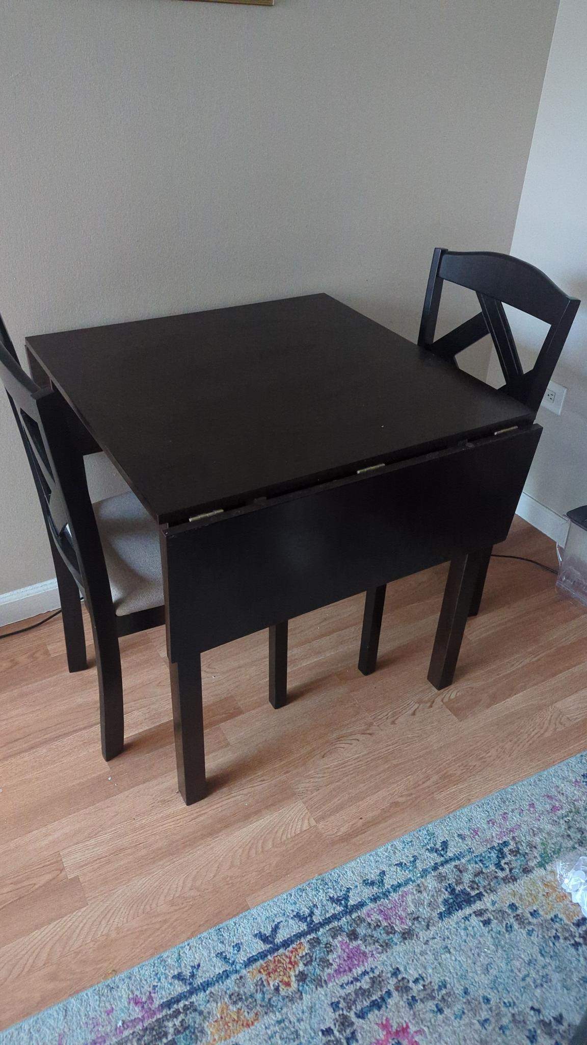 Dining table with two collapsible leaves