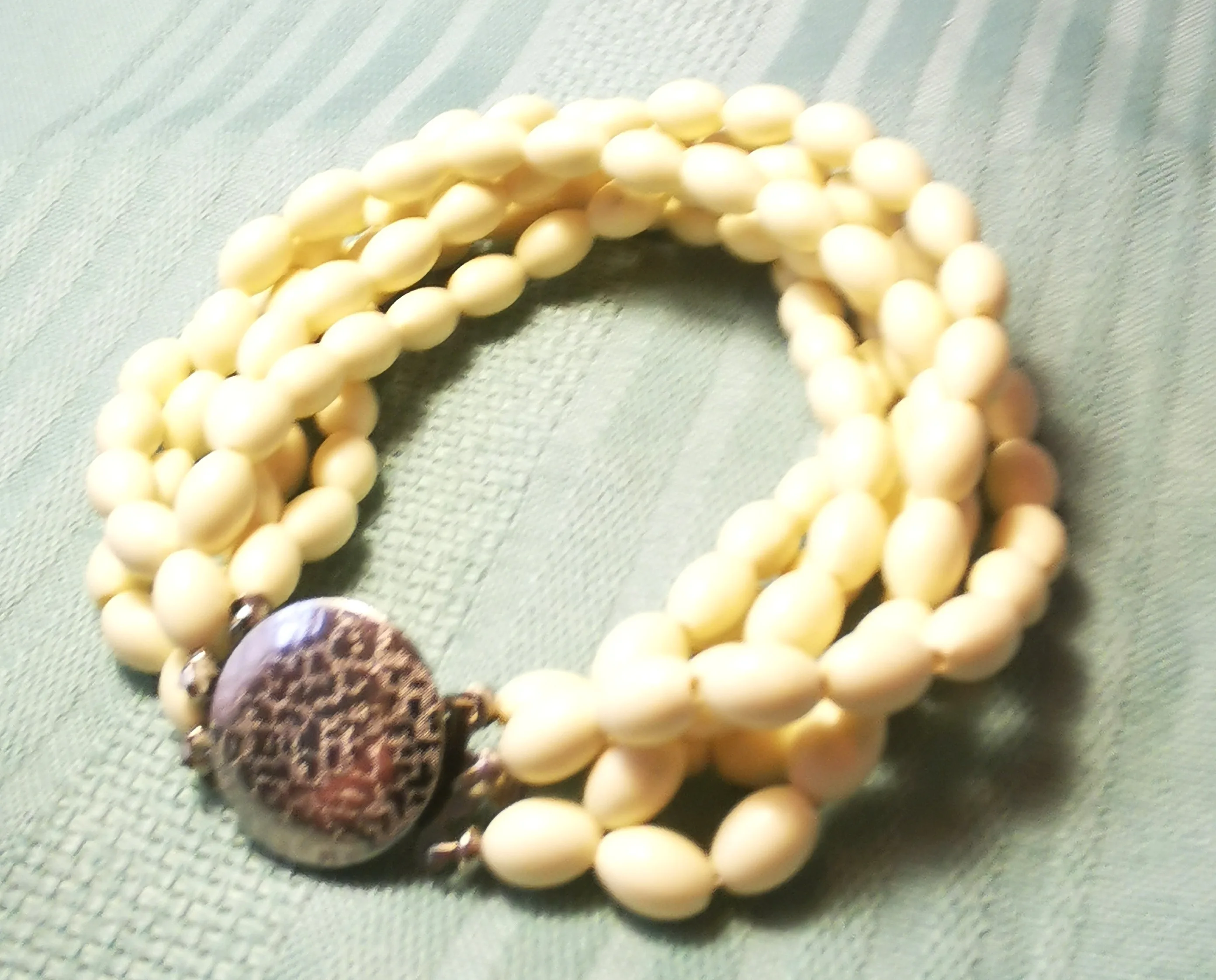 Multi-Strand White Bead Bracelet with Ornate Silver-Tone Clasp image indicator(3)