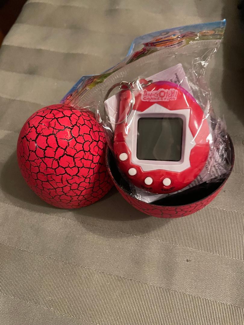 Still in package Red egg/Red Tamagotchi toy