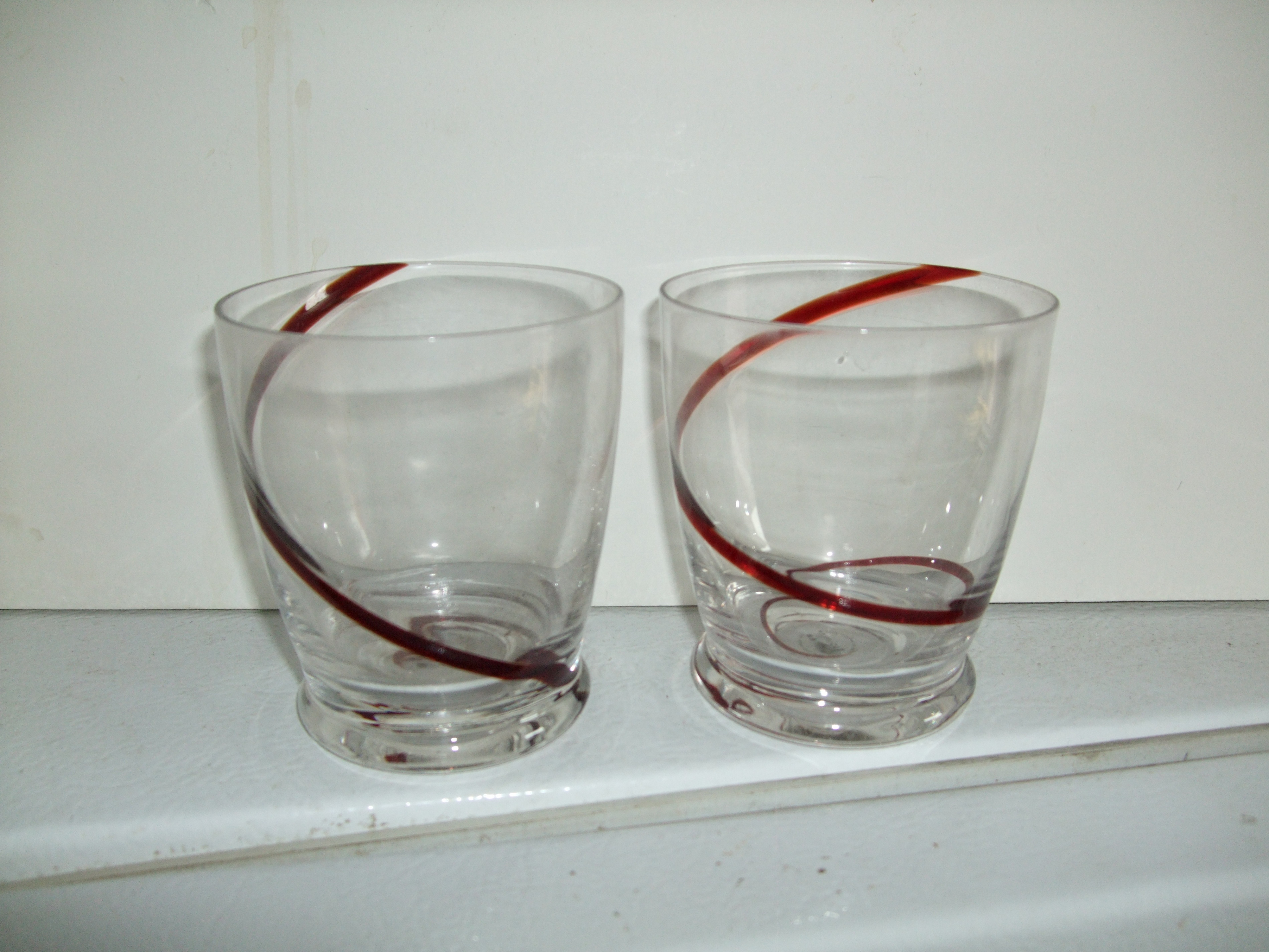 Pair of Clear Drinking Glasses with Red Swirl