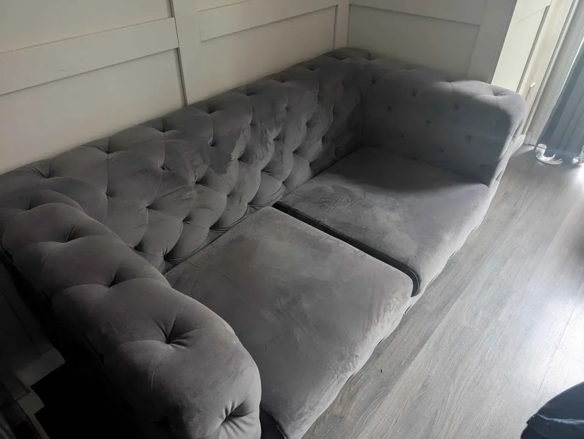 Gray tufted velvet Chesterfield-style sofa