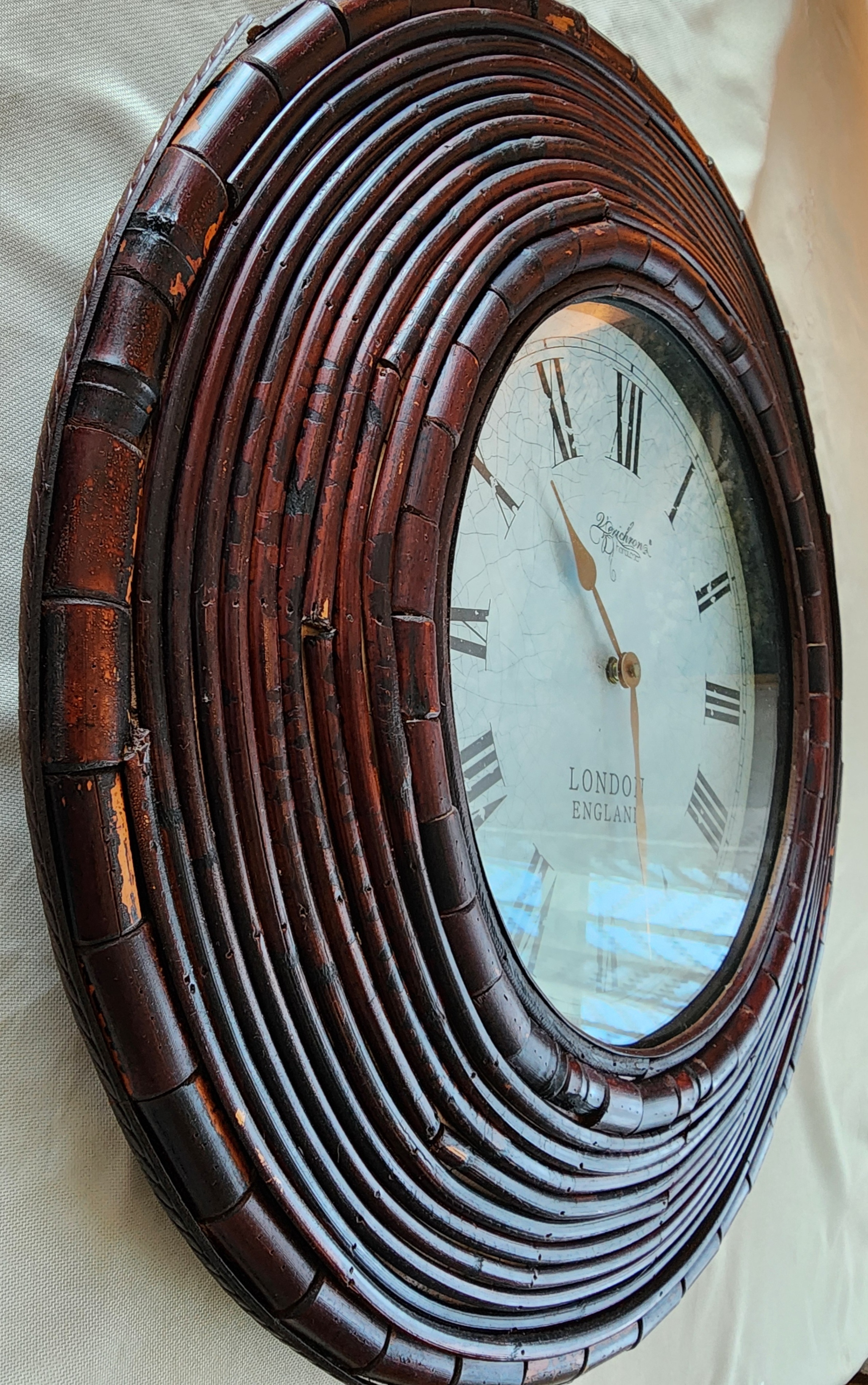 Vintage‐style wall clock with dark wood frame and Roman numerals