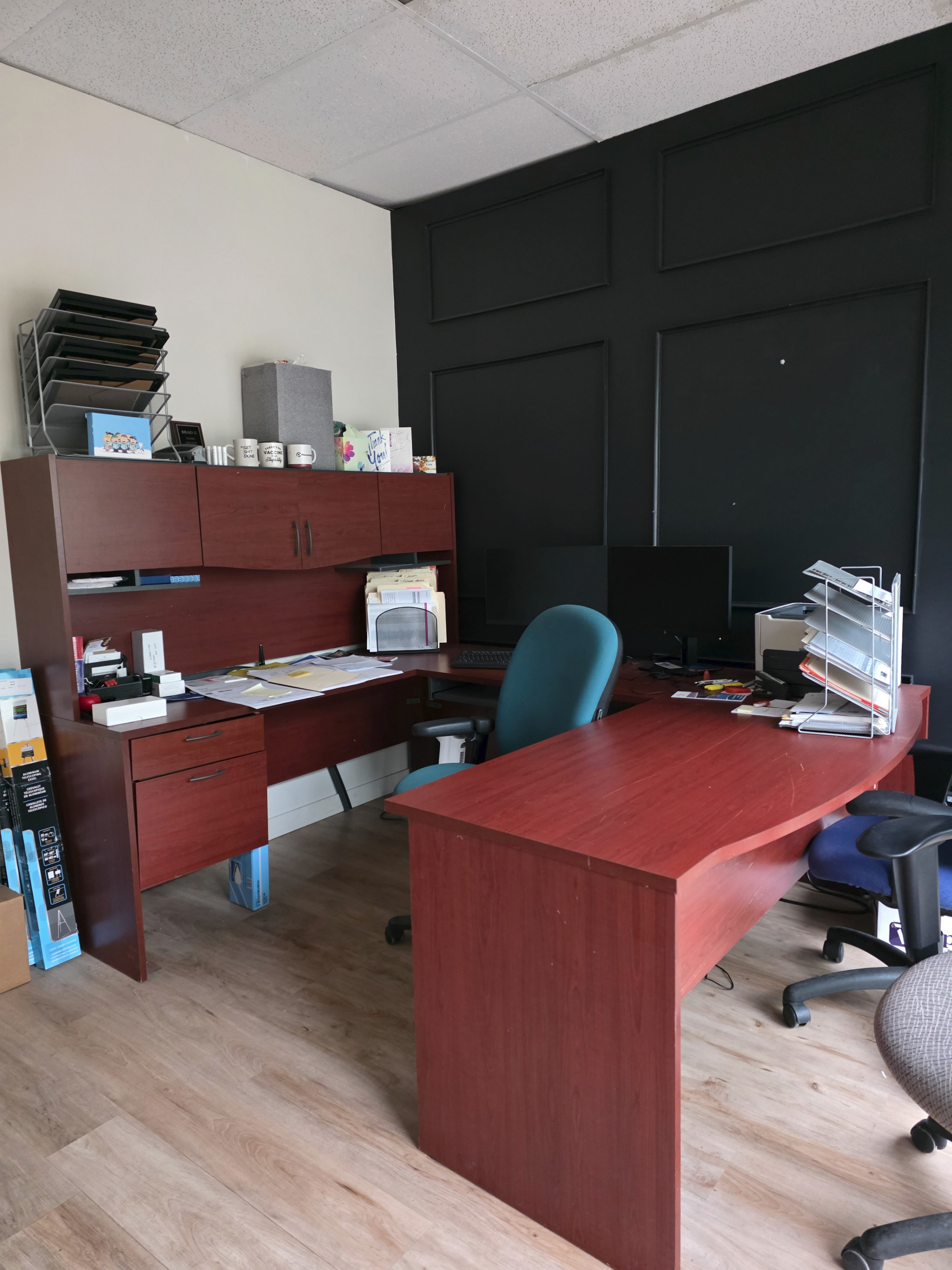 Large executive-style office desk with matching hutch/storage.