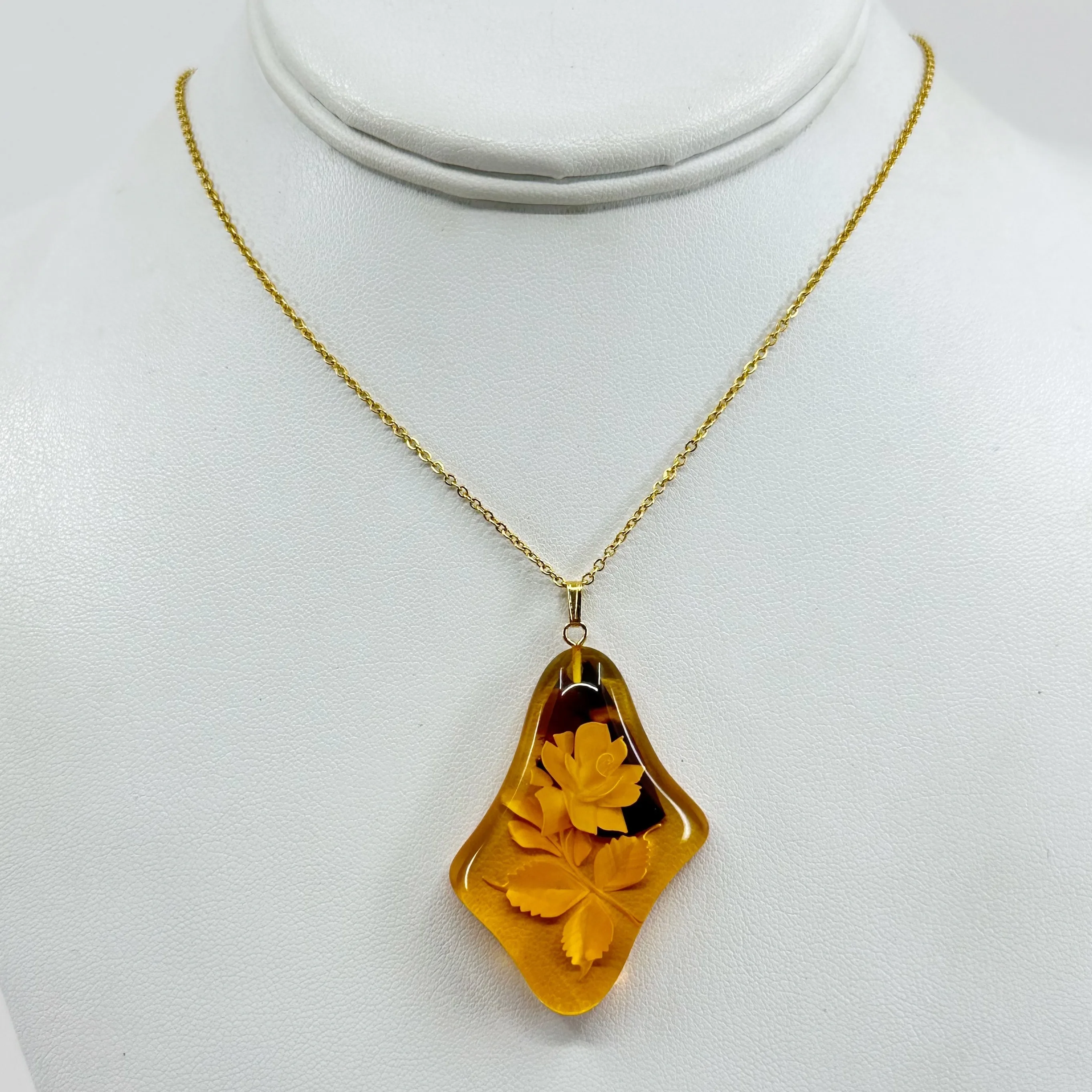 Gold tone reverse carved rose baltic amber pendant necklace
