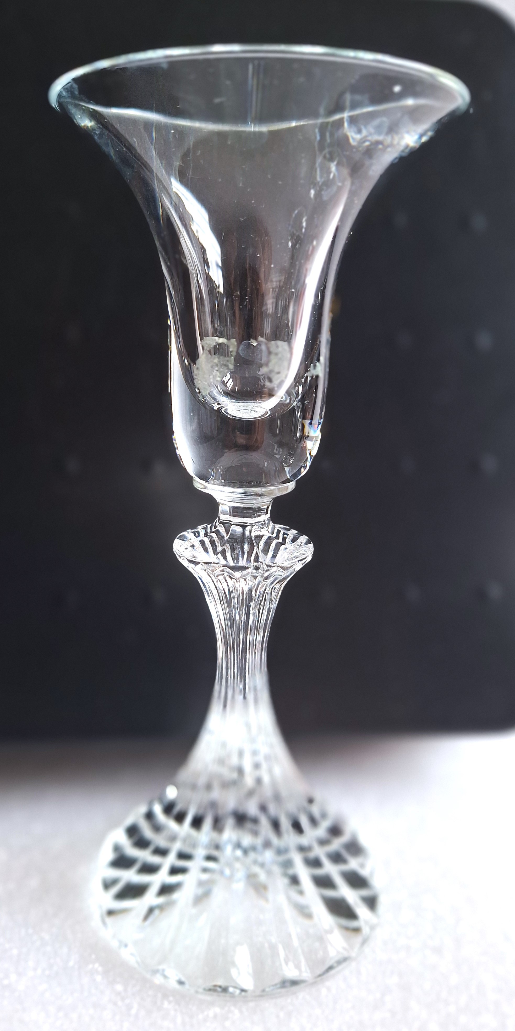 Two clear glass candlesticks with fluted bases