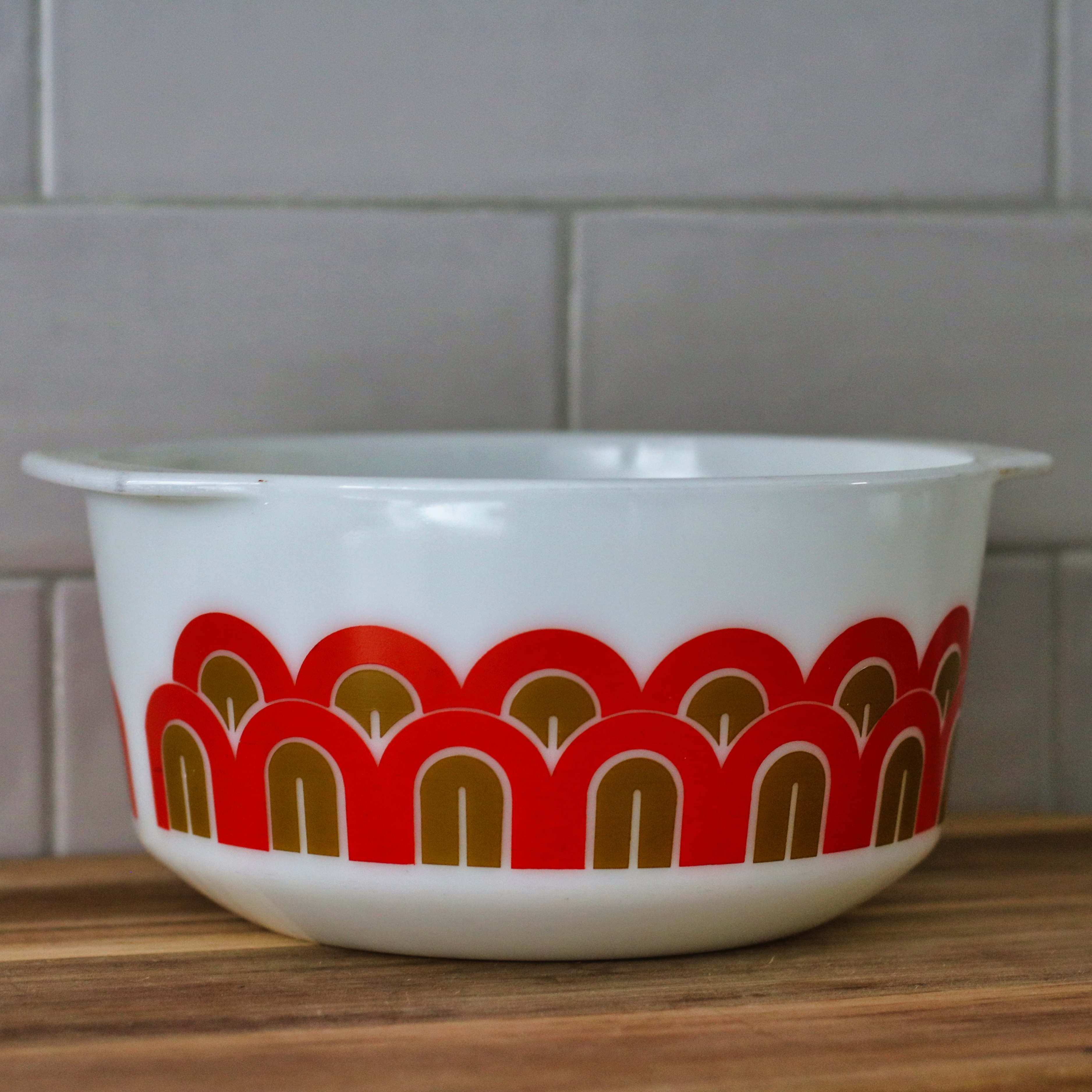 Vintage Pyrex arc-pattern red and golden brown medium bowl