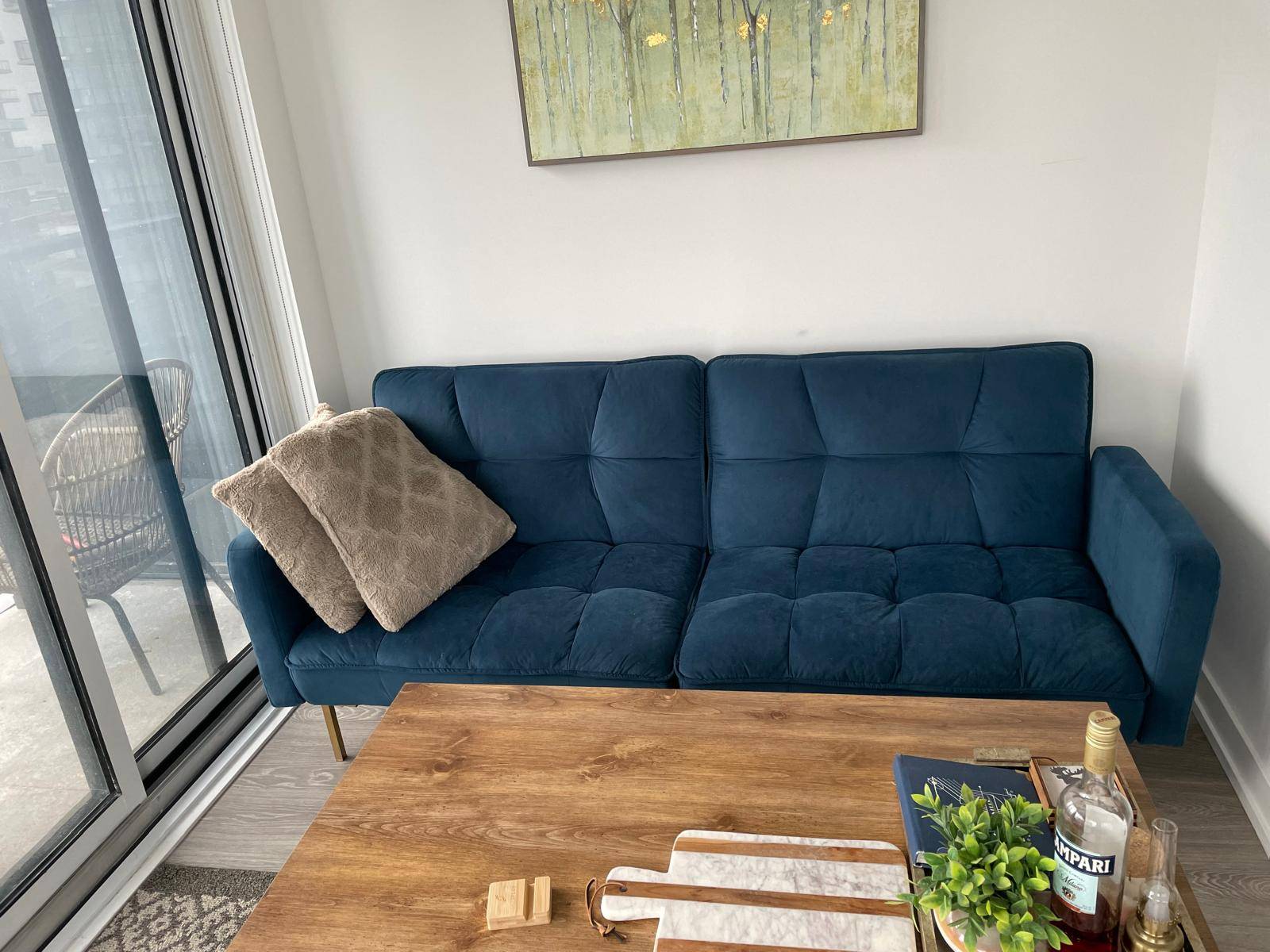 Navy blue sofa-bed with channel tufting