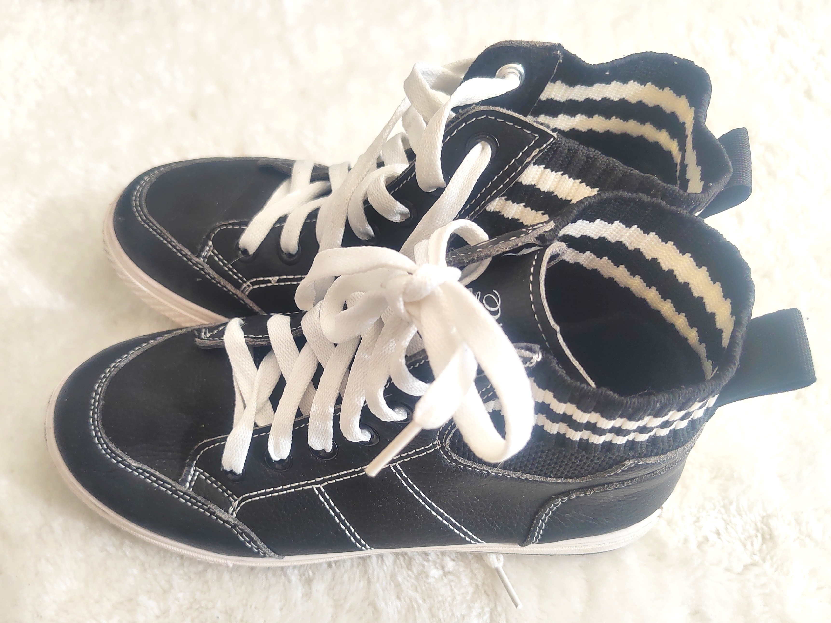 Black high-top sneakers with white laces