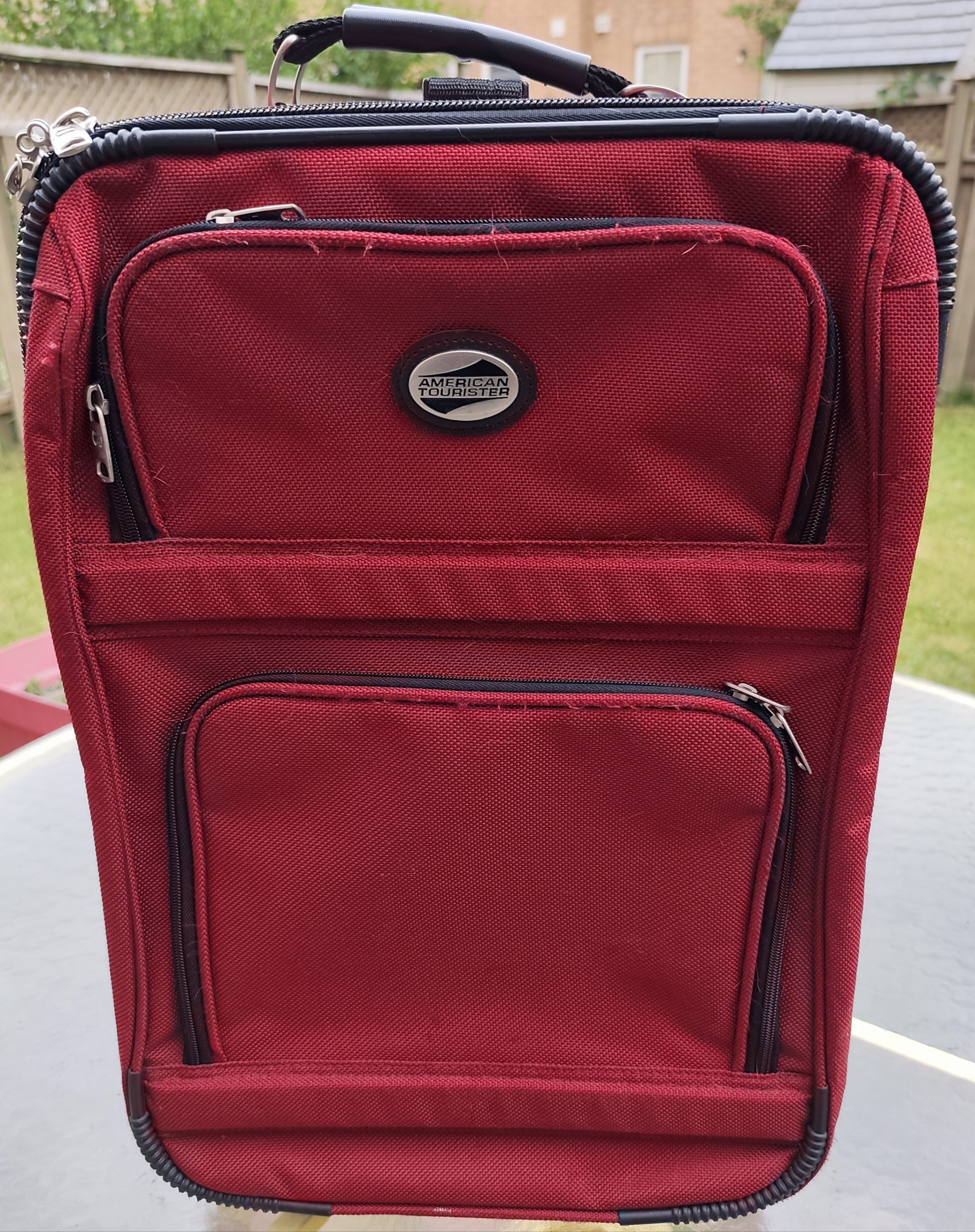 American Tourister carry on luggage with telescopic pull handle