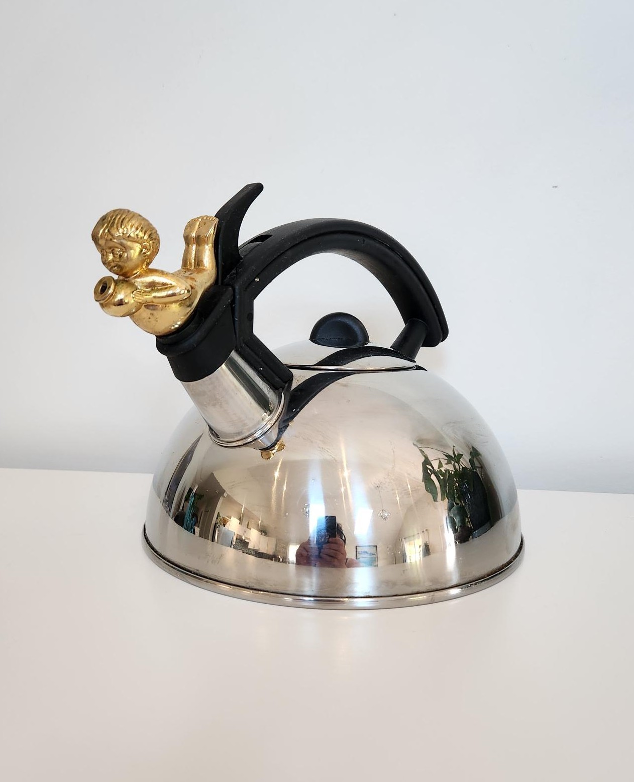 Stainless Steel Kettle Adorned with a Cherub/Child Pouring Water