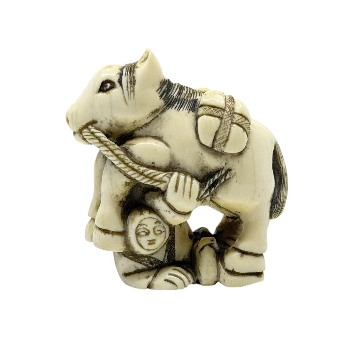 Meiji - Showa period Japanese bone Man under a horse netsuke