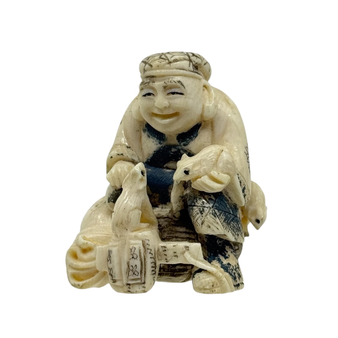 Meiji period carved bone man with mice netsuke