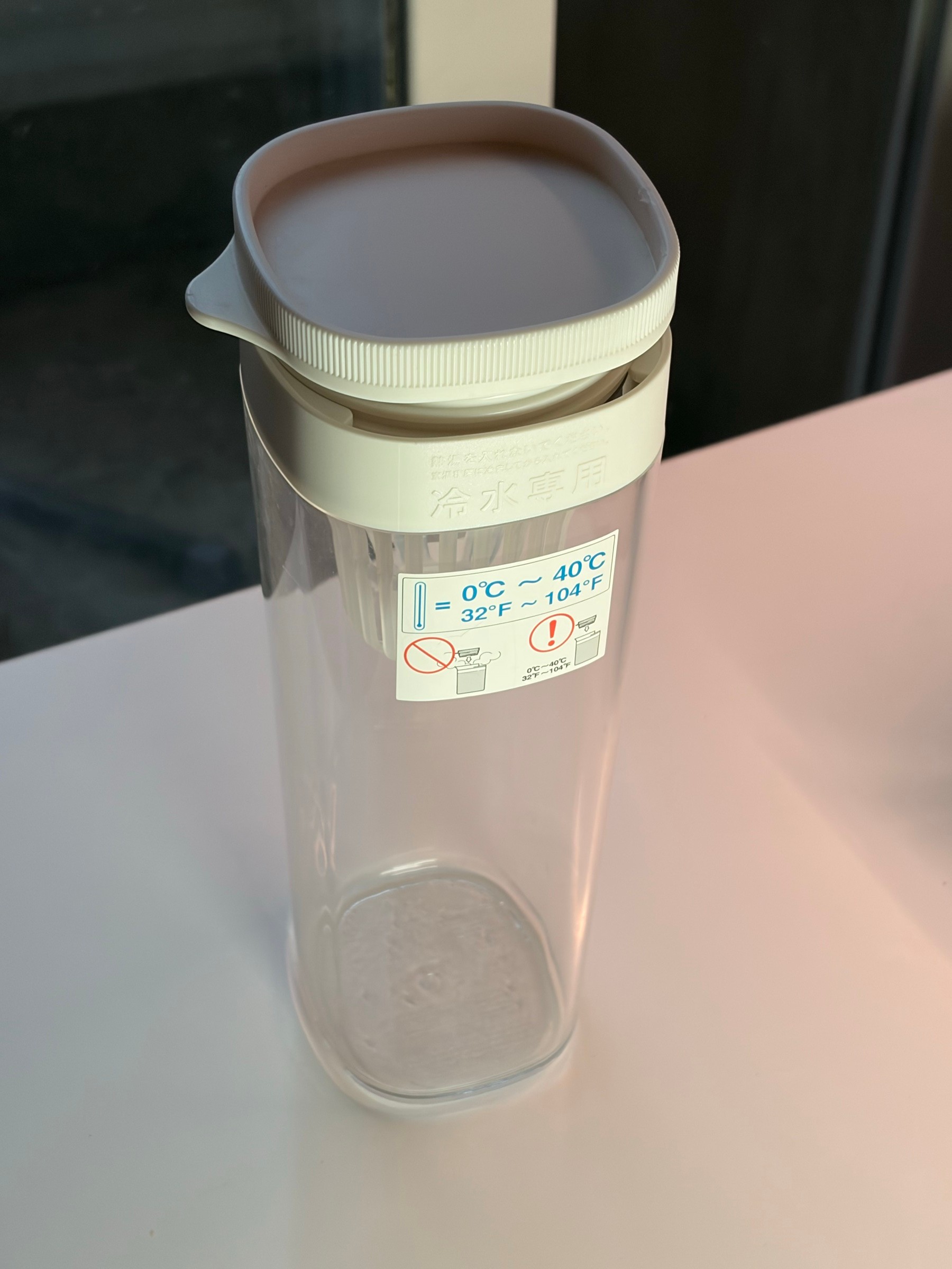 Clear plastic cold water pitcher with strainer lid