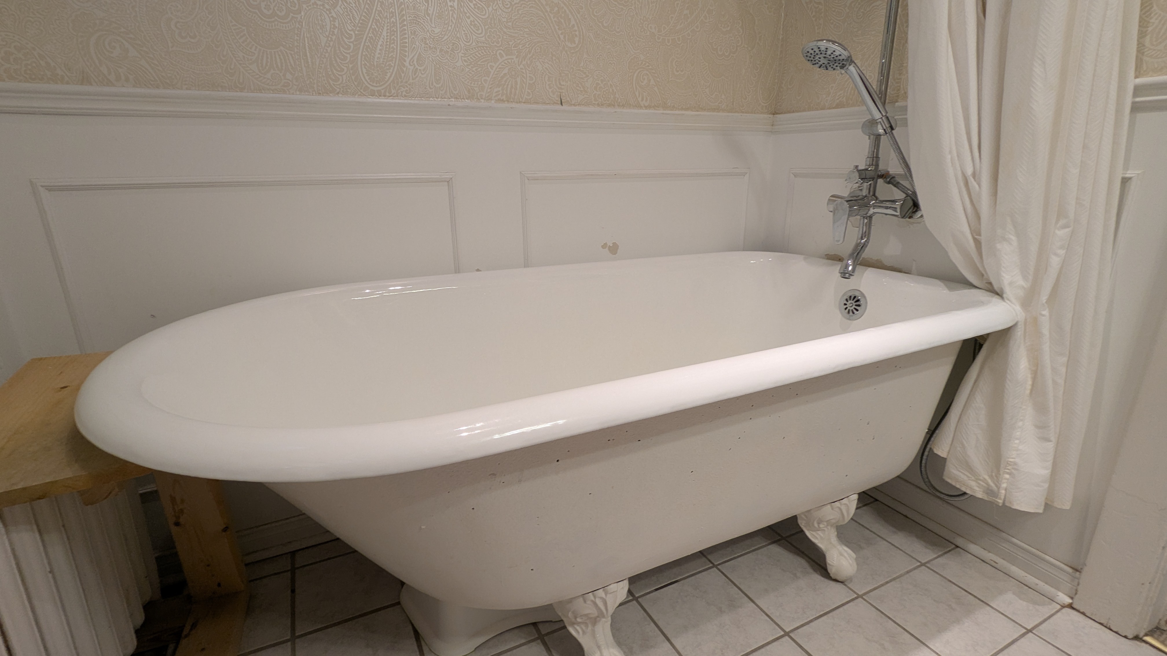Clawfoot Bathtub + shower curtain rod + bath/shower fixture