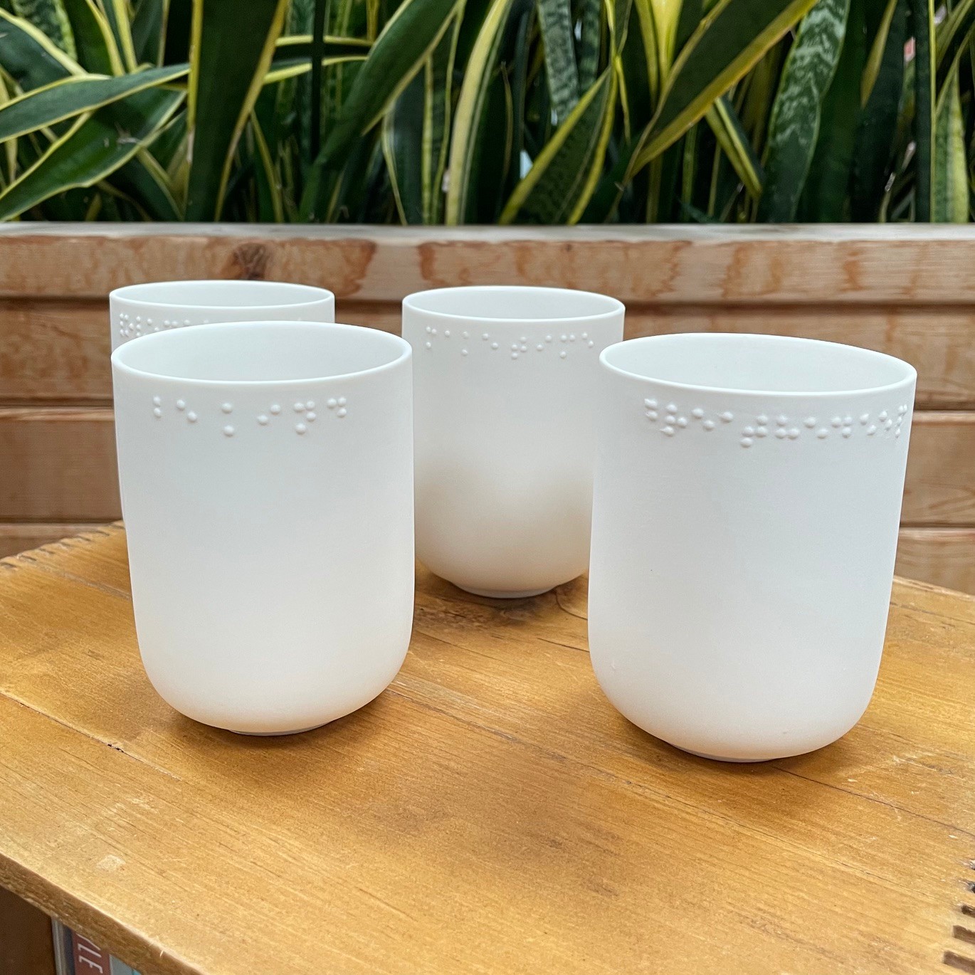 4 Porcelain Cups with Braille Messages by Liv Andersson