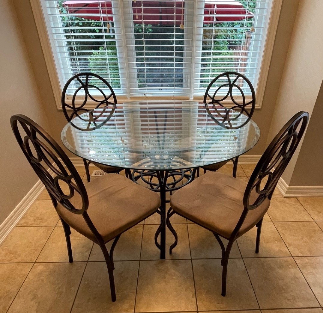 Wrought Iron Dining table with glass top and 4 patterned chairs