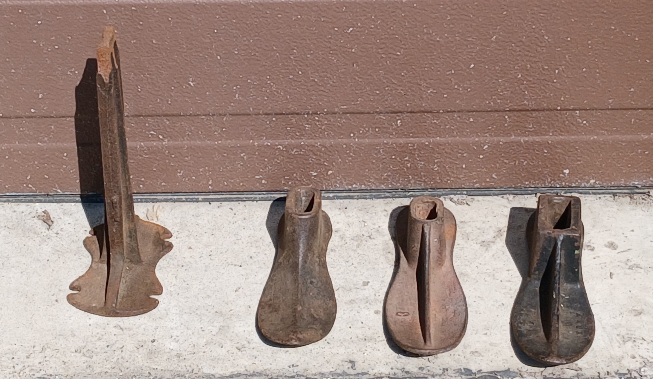 Set of 3 antique cast iron cobbler shoe forms with stand