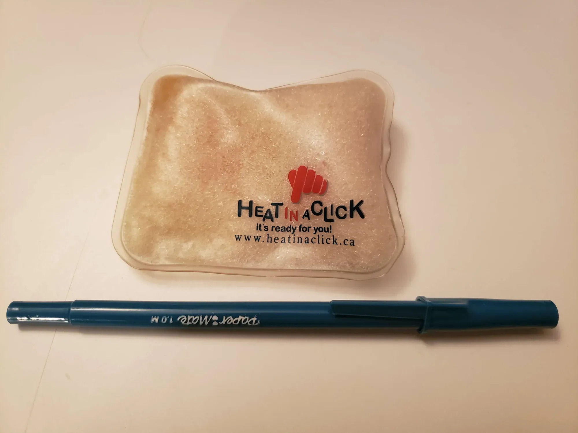 "Heat In A Click" Heat-Holding Pack (pen for scale)