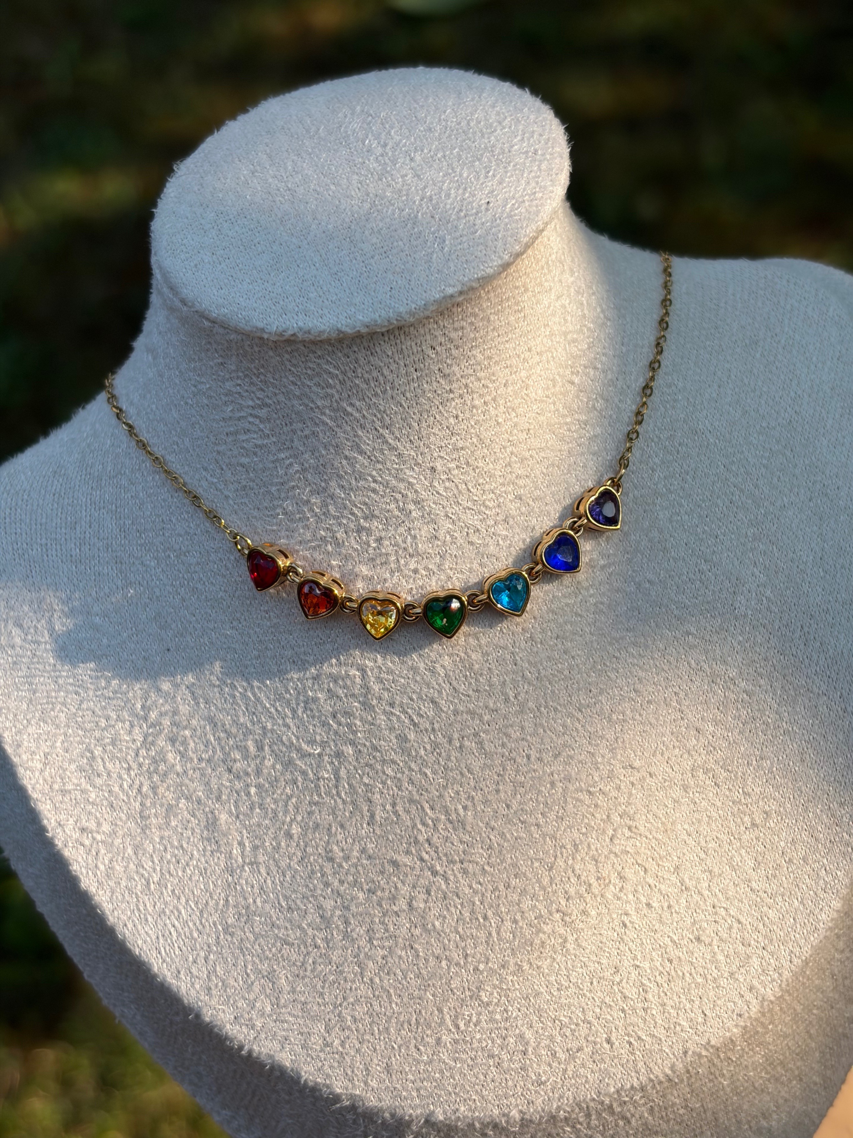 Gold tone necklace with multi-coloured heart