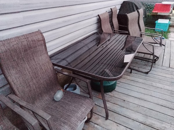 Glass top patio table with chairs