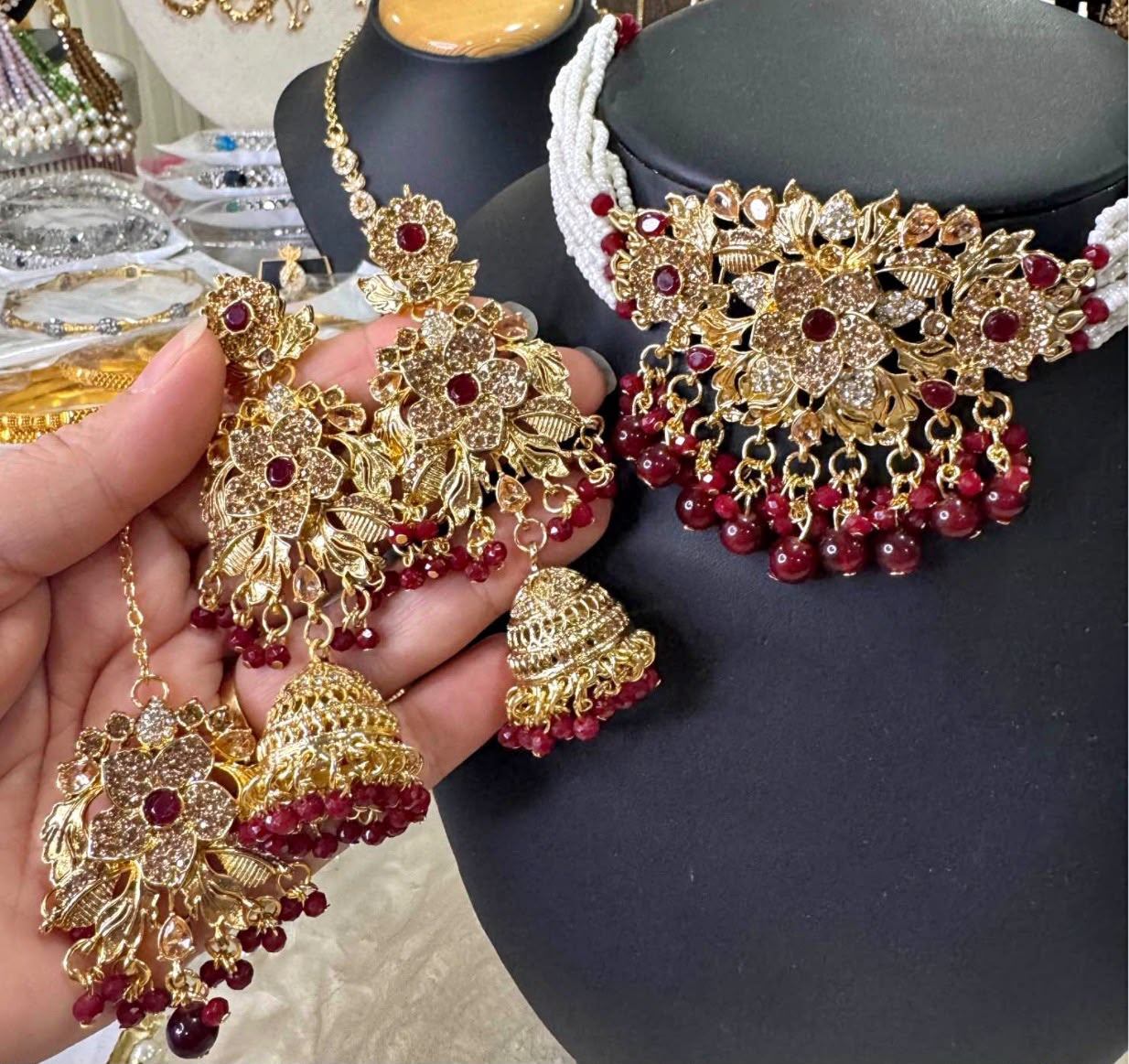 Gold-toned Ruby Coloured Floral Choker, Earrings and Tikka Set