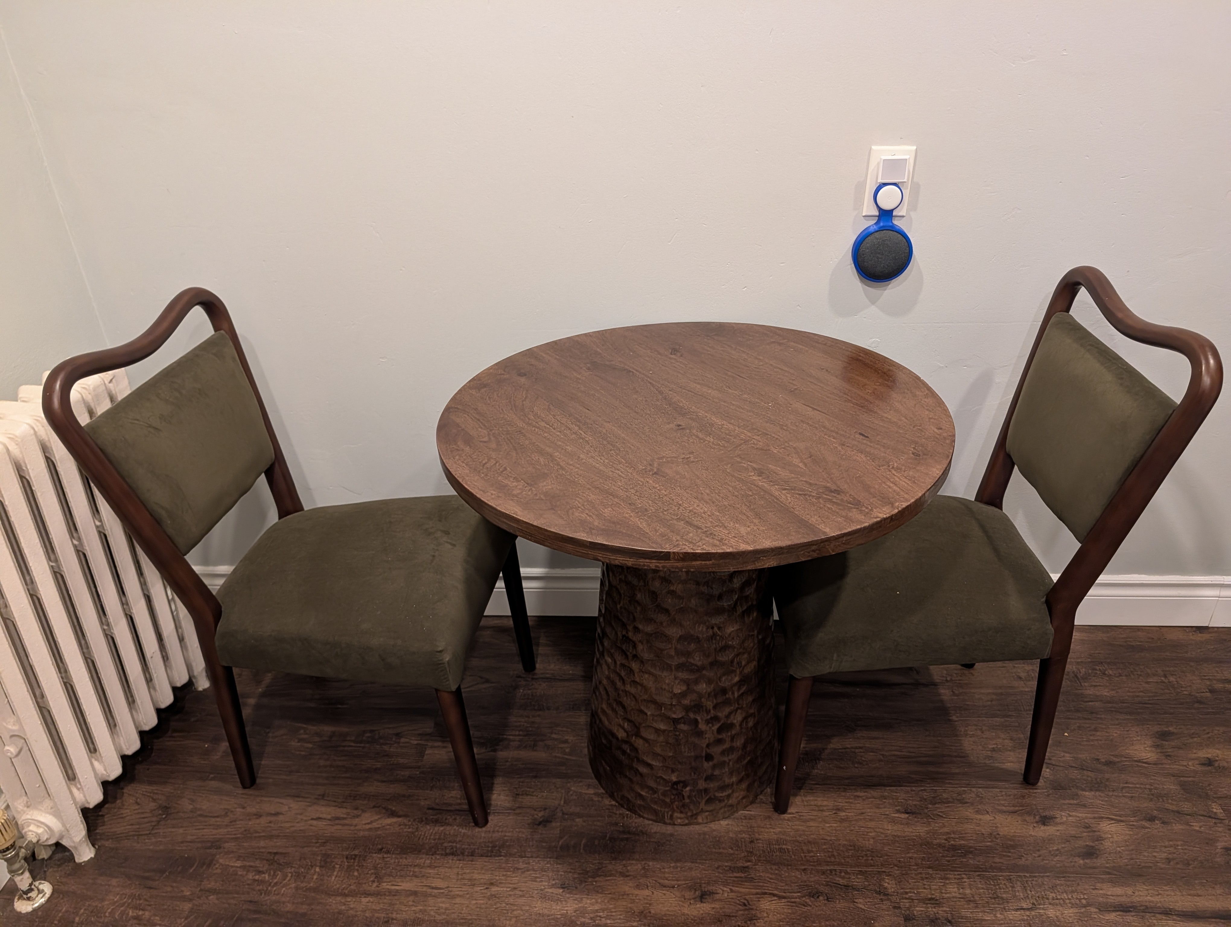Round wooden bistro table with two chairs