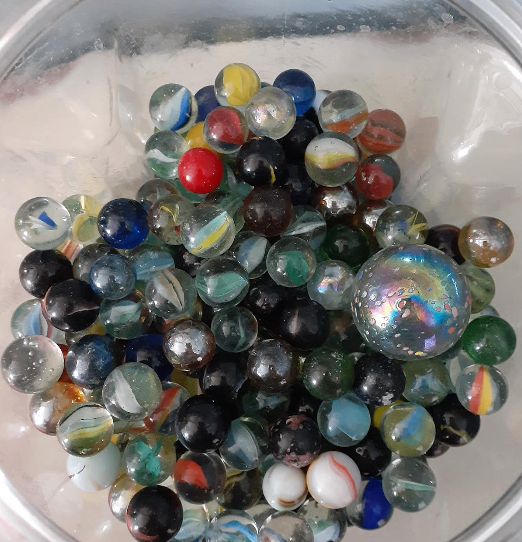 Large container of assorted vintage glass marbles