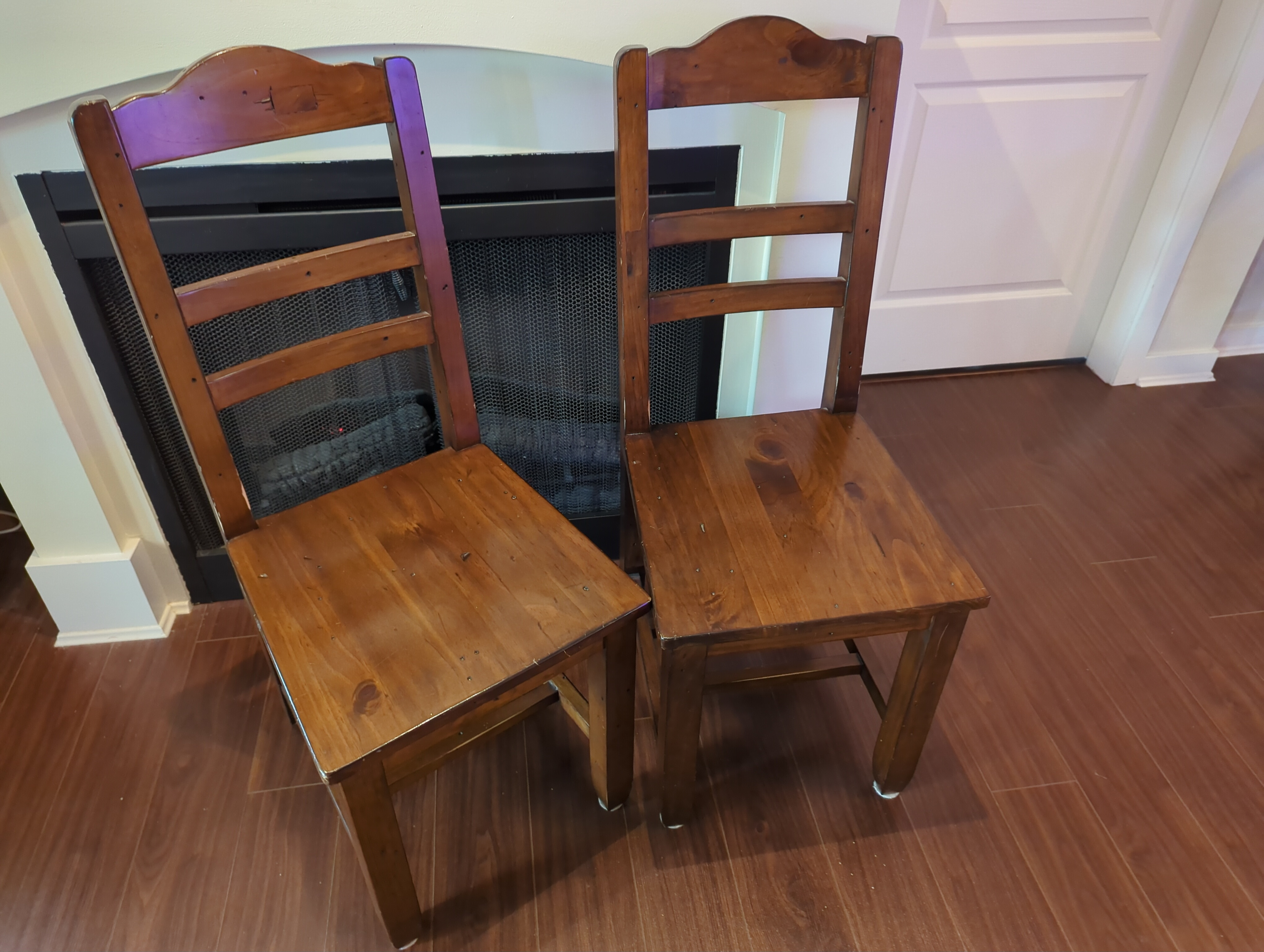 Two solid wood dining chairs