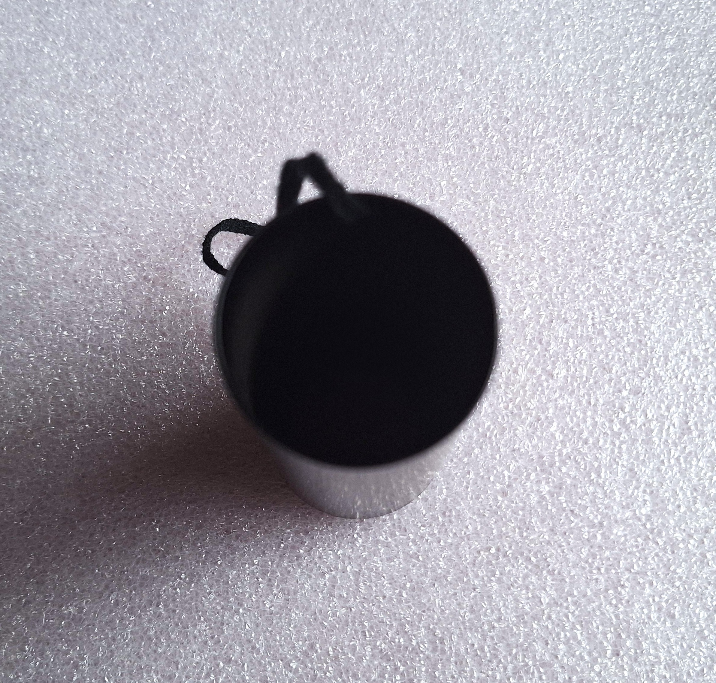 Black cylindrical container with hanging cord - photo 2
