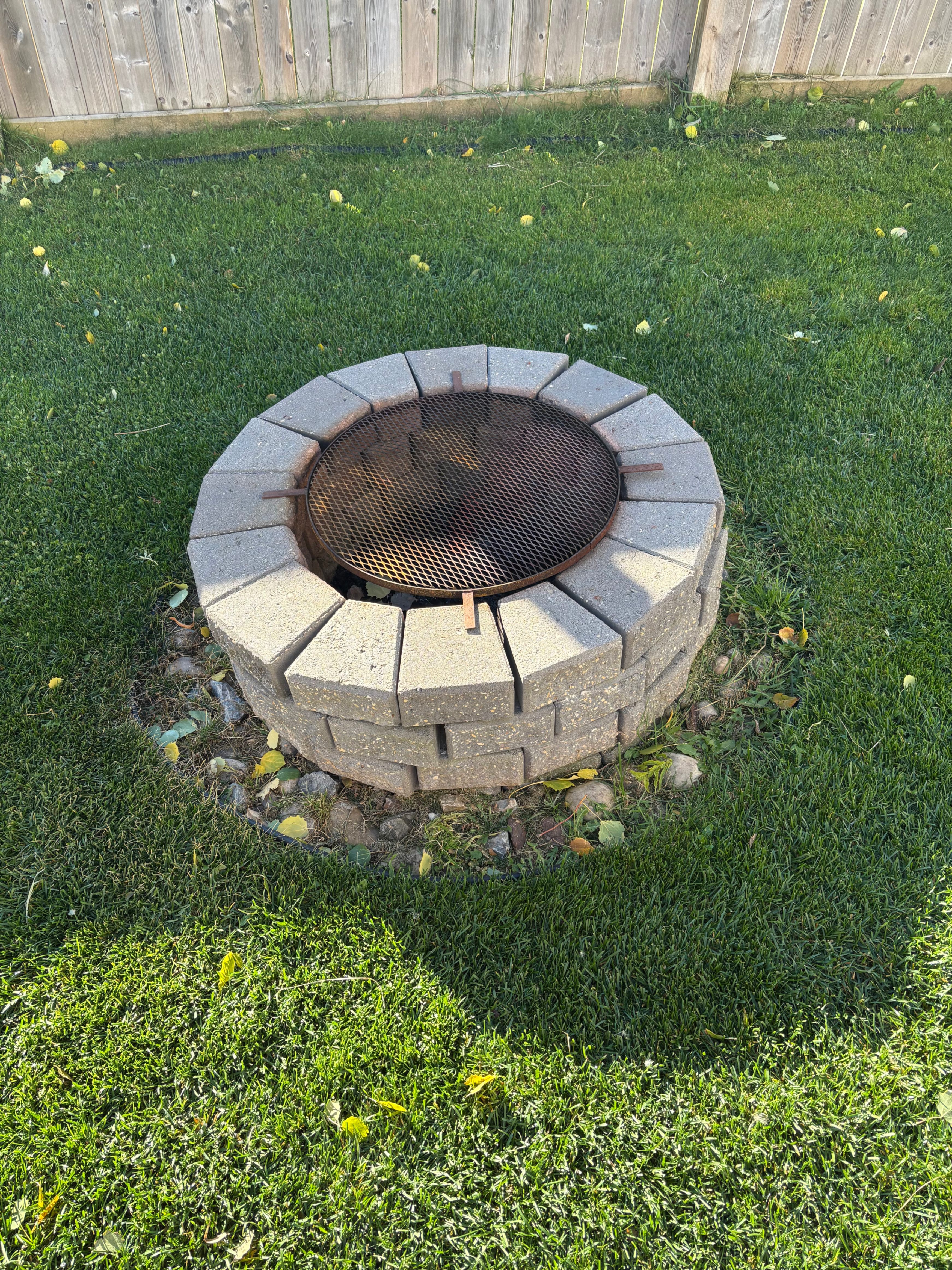 Backyard Firepit Stones and Grille