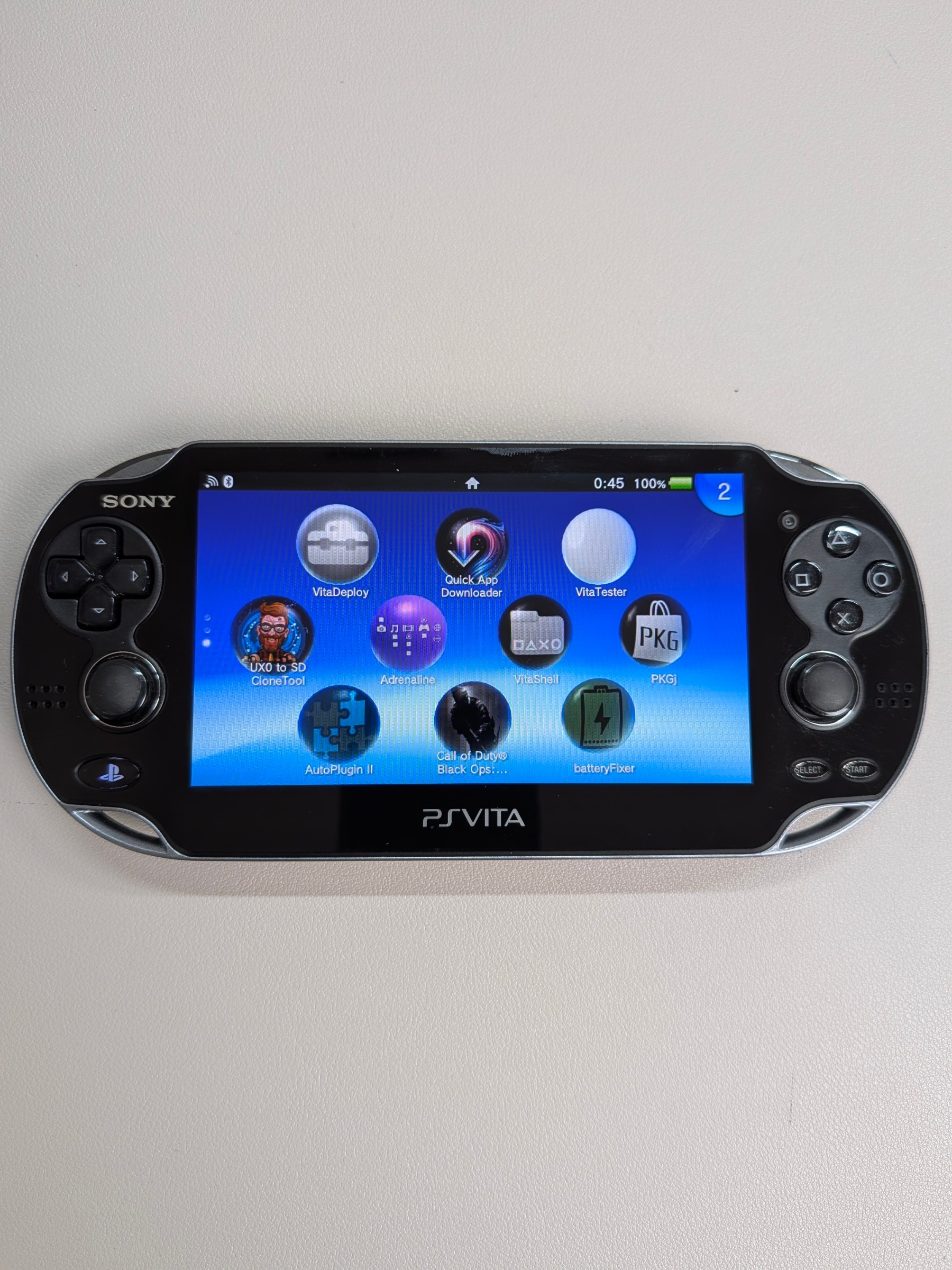 PS Vita 1000 Black Like-New, Charger + 64GB Card