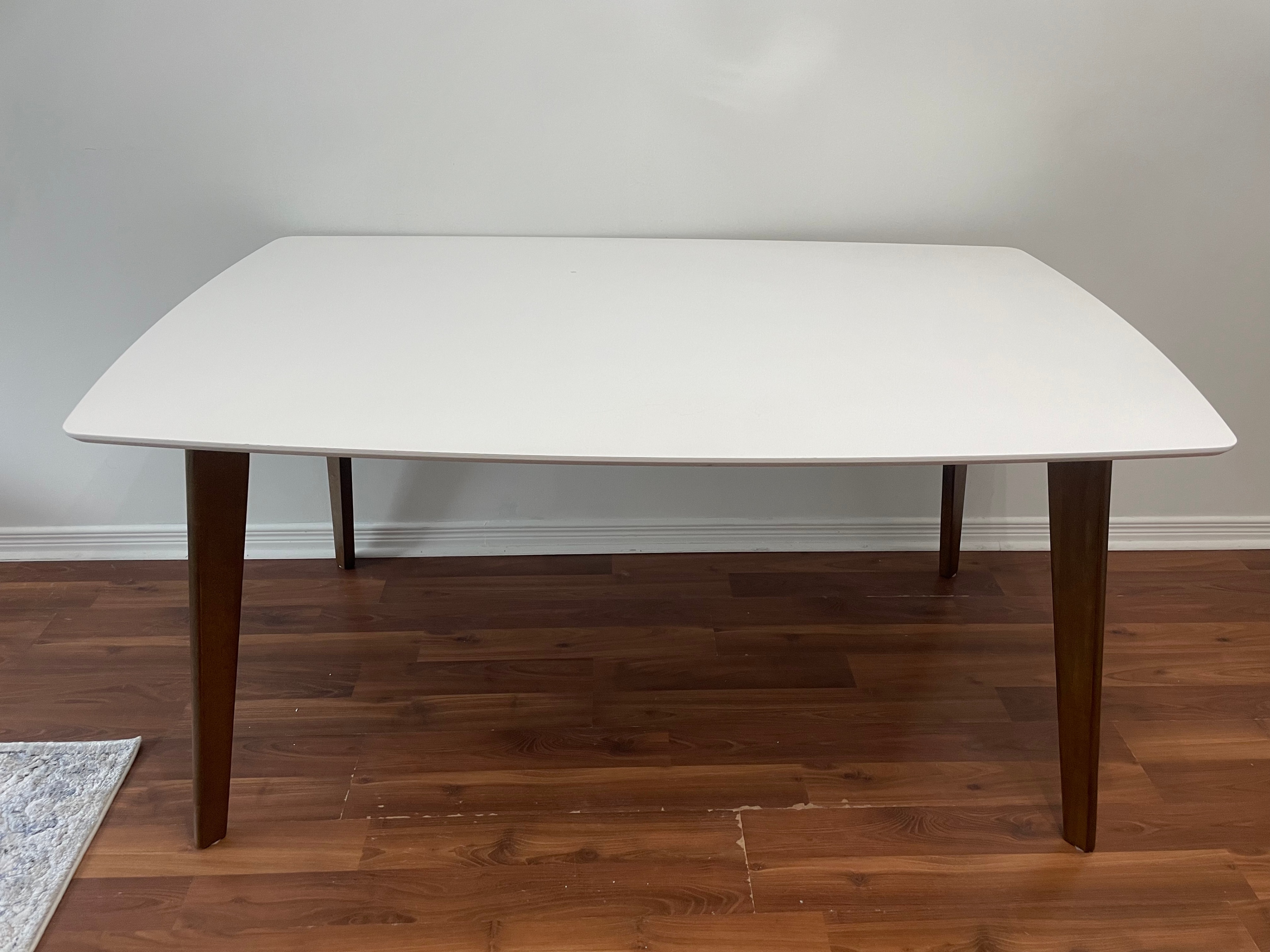 White dining table with wood legs