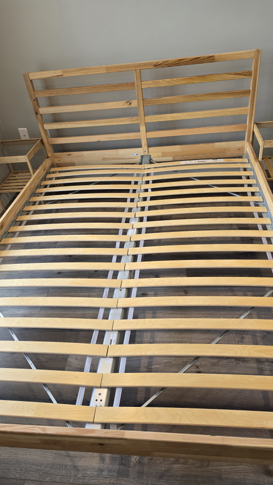 IKEA Wooden bed frame with two nightstands.