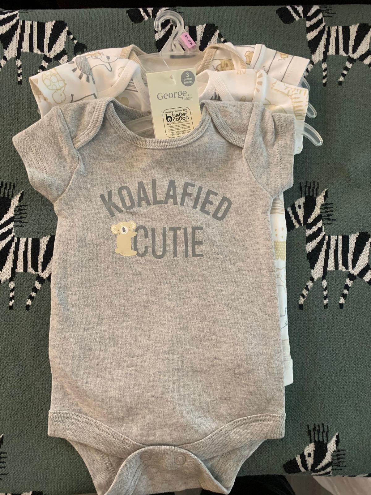 Assorted baby onesies and sizes