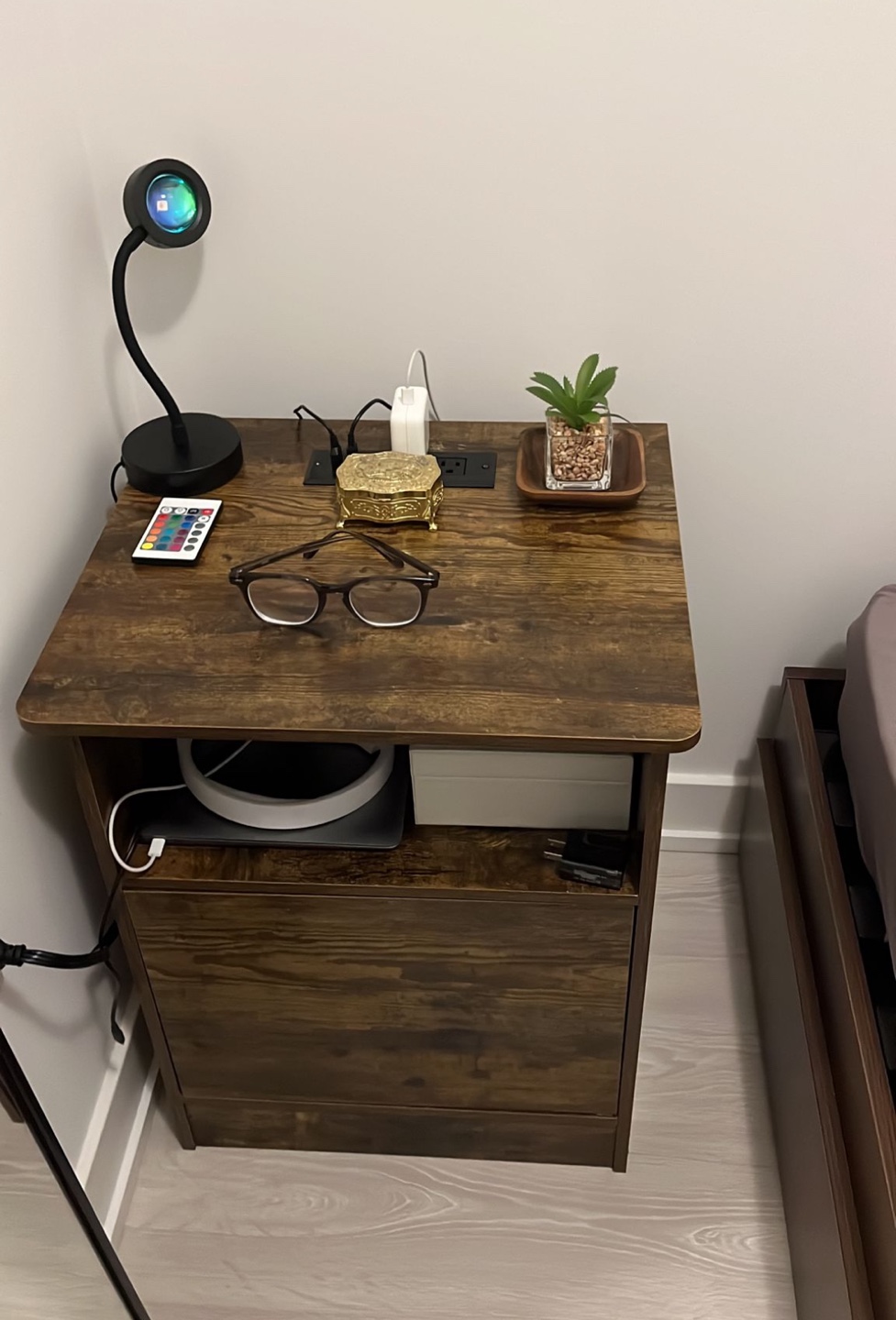 Wooden bedside table with charging outlet