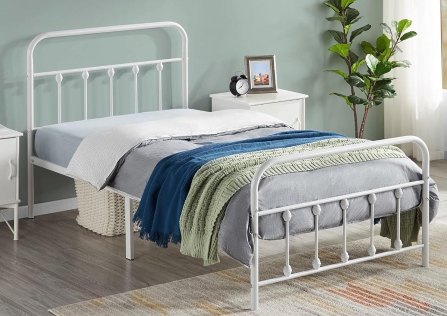 Twin bed, white metal frame.