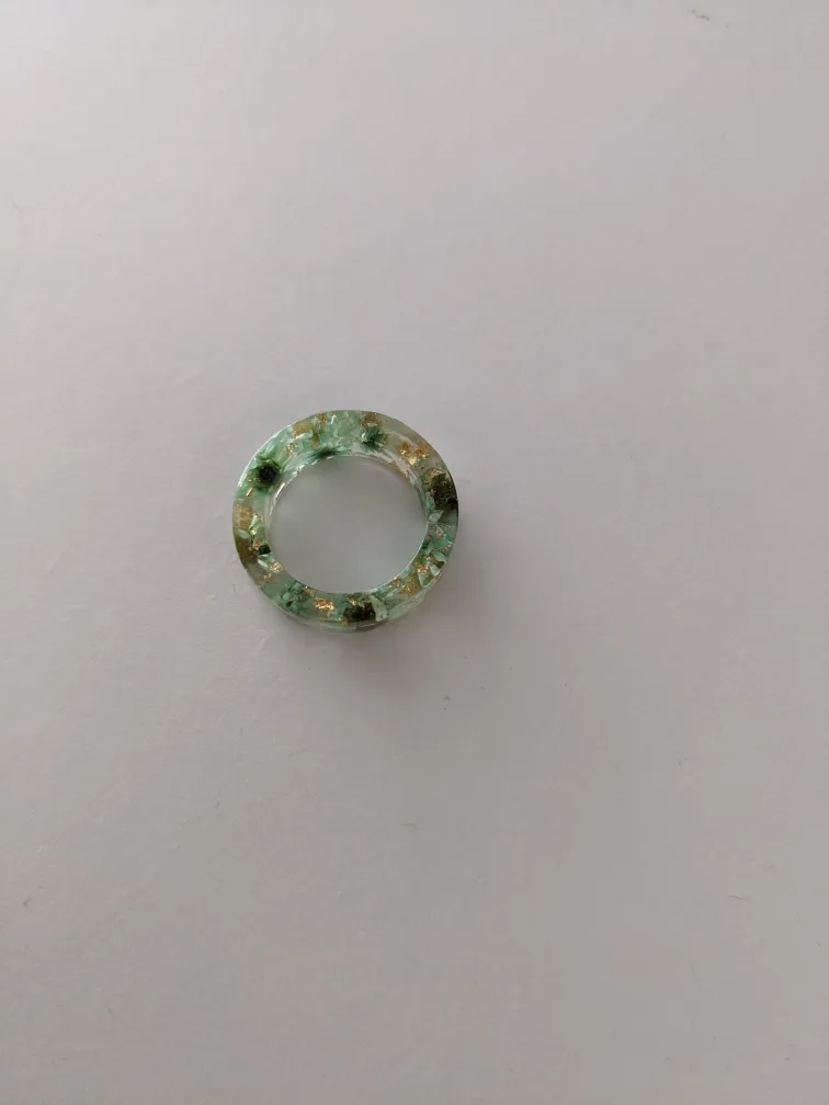 green/jade resin ring with floral/gold accents image indicator(2)