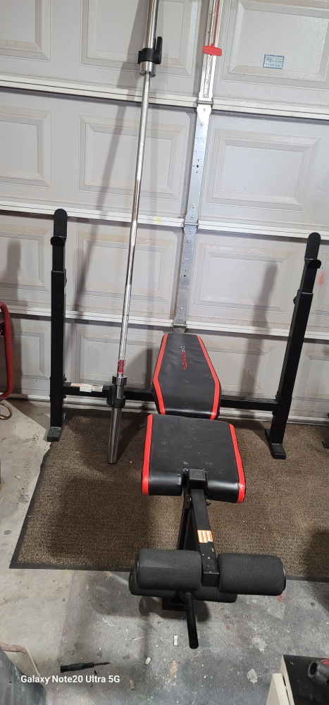 Weight Bench with Barbell and Weights