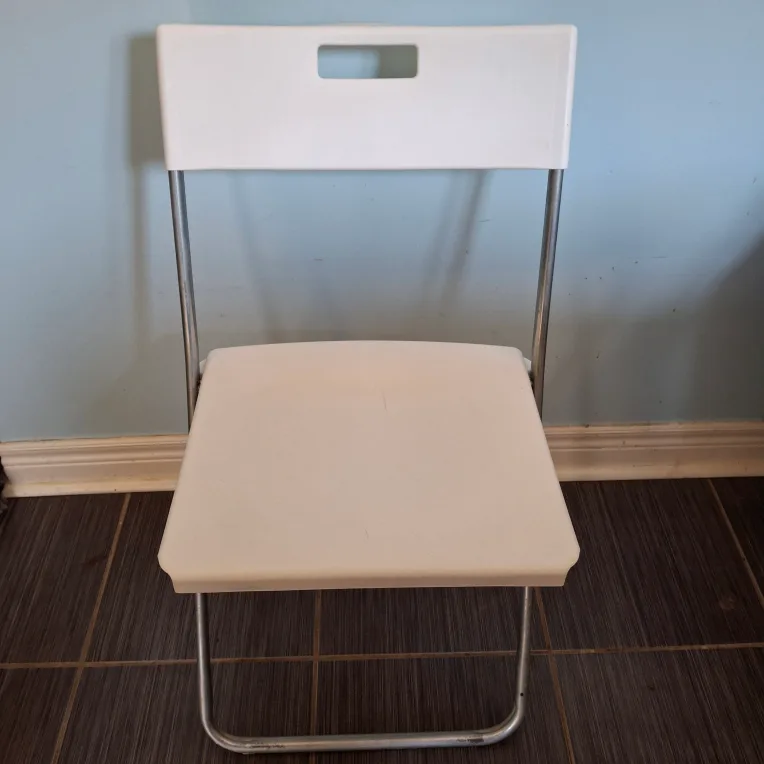 White plastic folding chair thumbnail