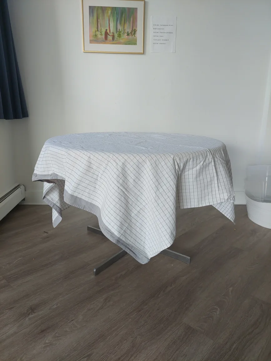Wooden circular table with cloth. thumbnail