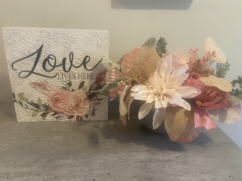 Love Lives Here Sign with Floral Arrangement