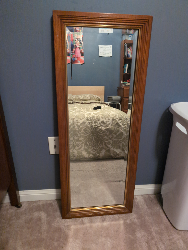 Full-length mirror with a wooden frame