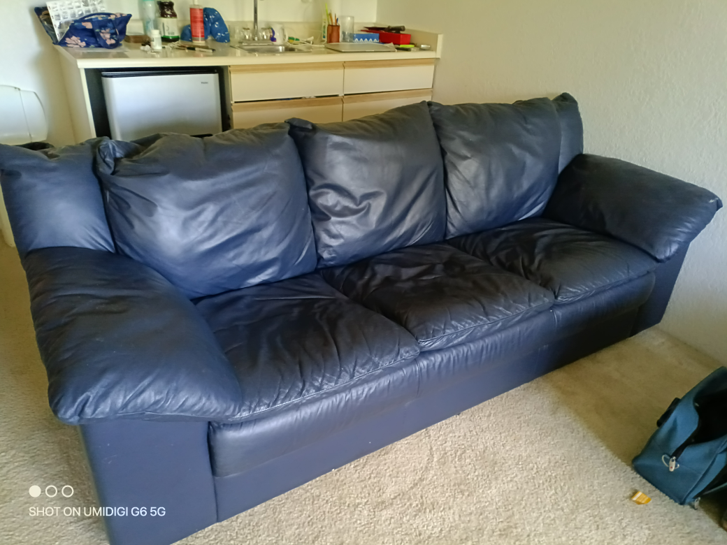 Beautiful large, dark navy leather sofa.