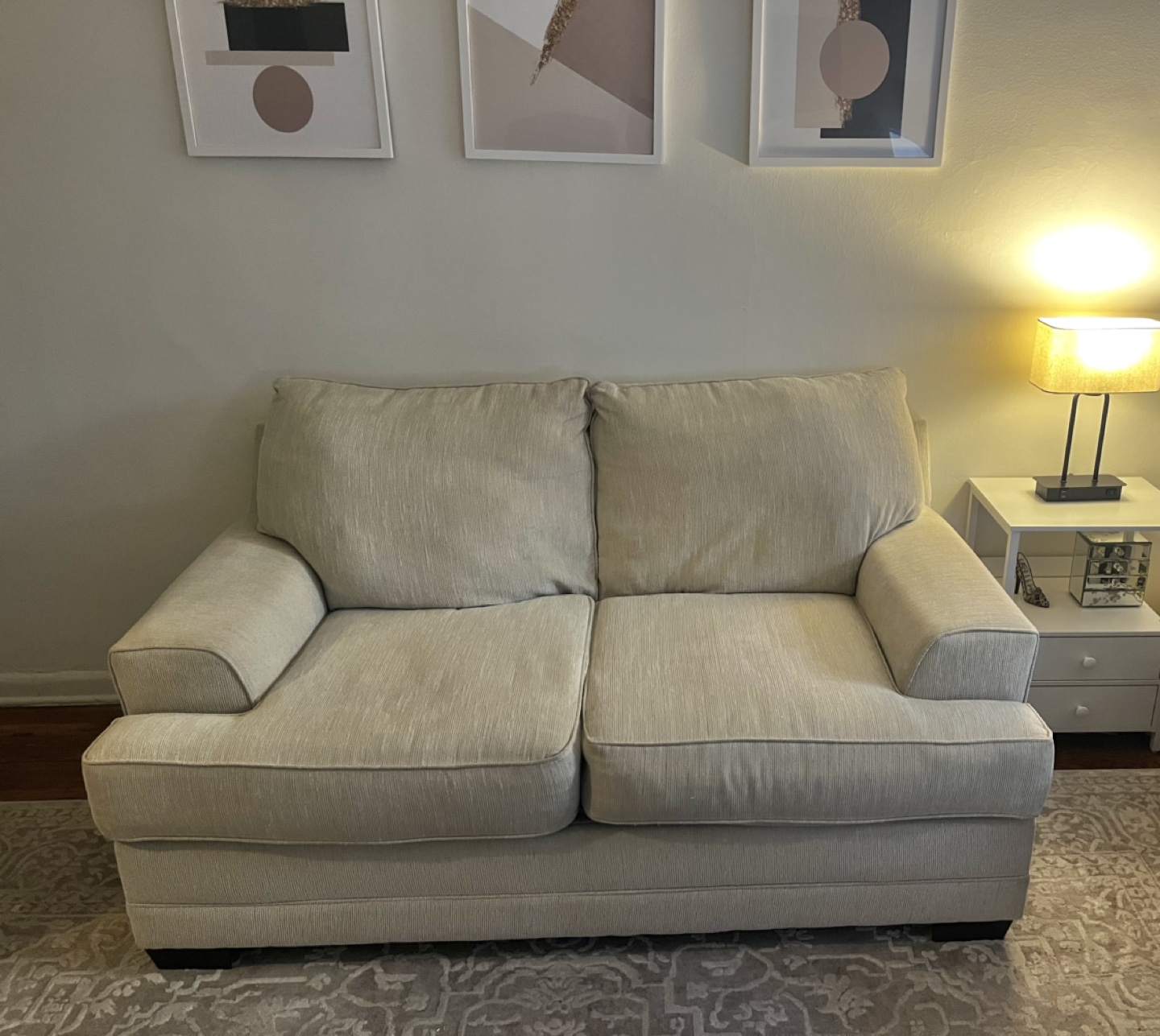 Beige two-cushion loveseat (in elevator building!)