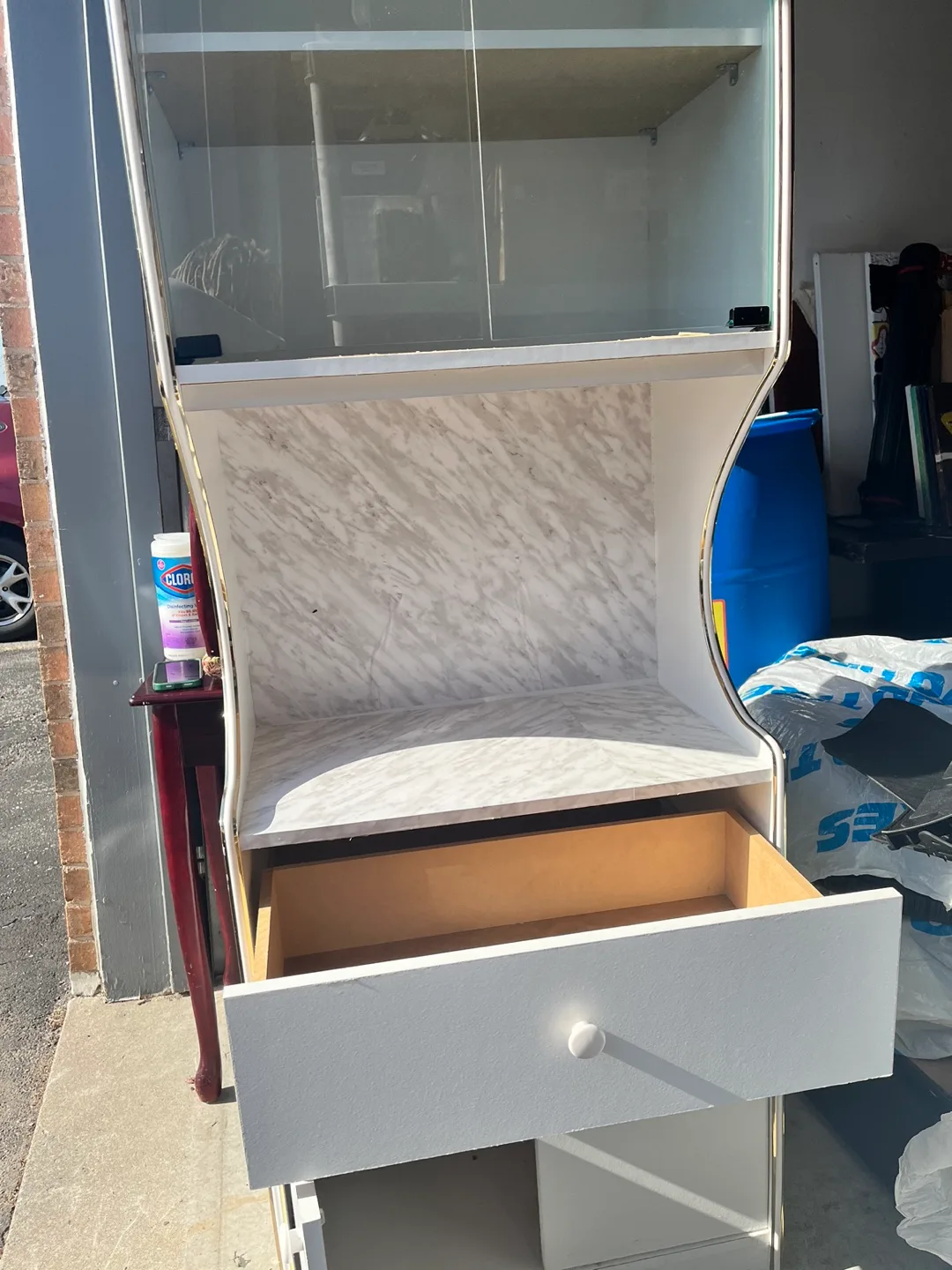 White cabinet with glass doors and marble-look top image indicator(2)