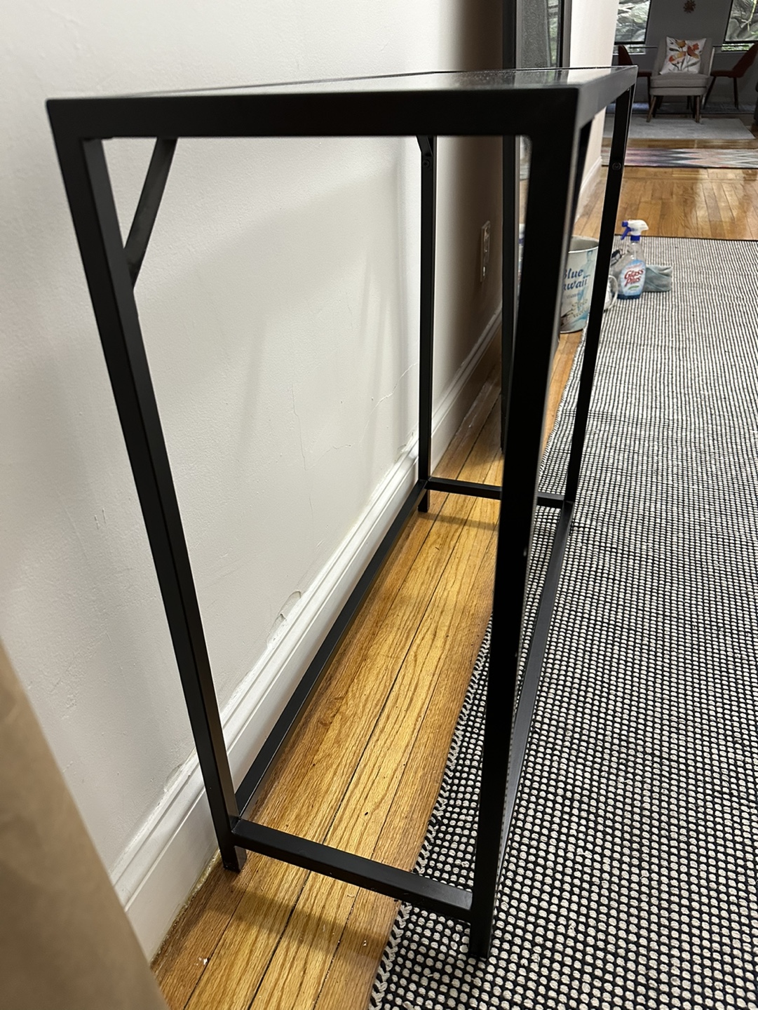 Glass and black metal console table