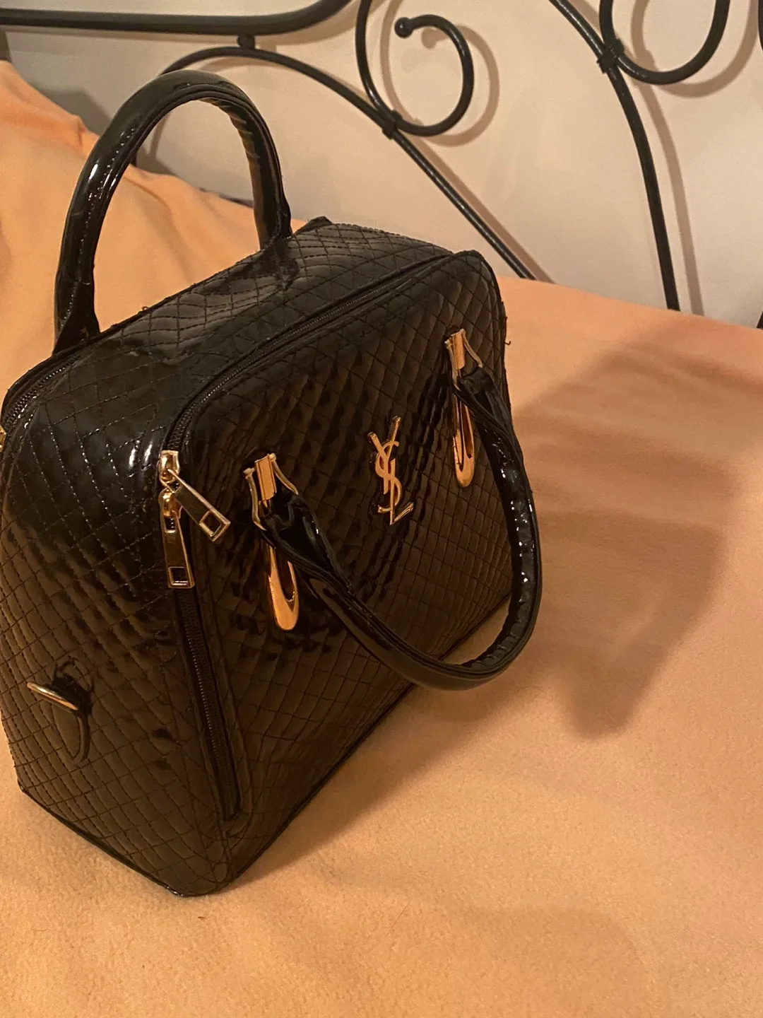 Black quilted handbag with gold accents thumbnail